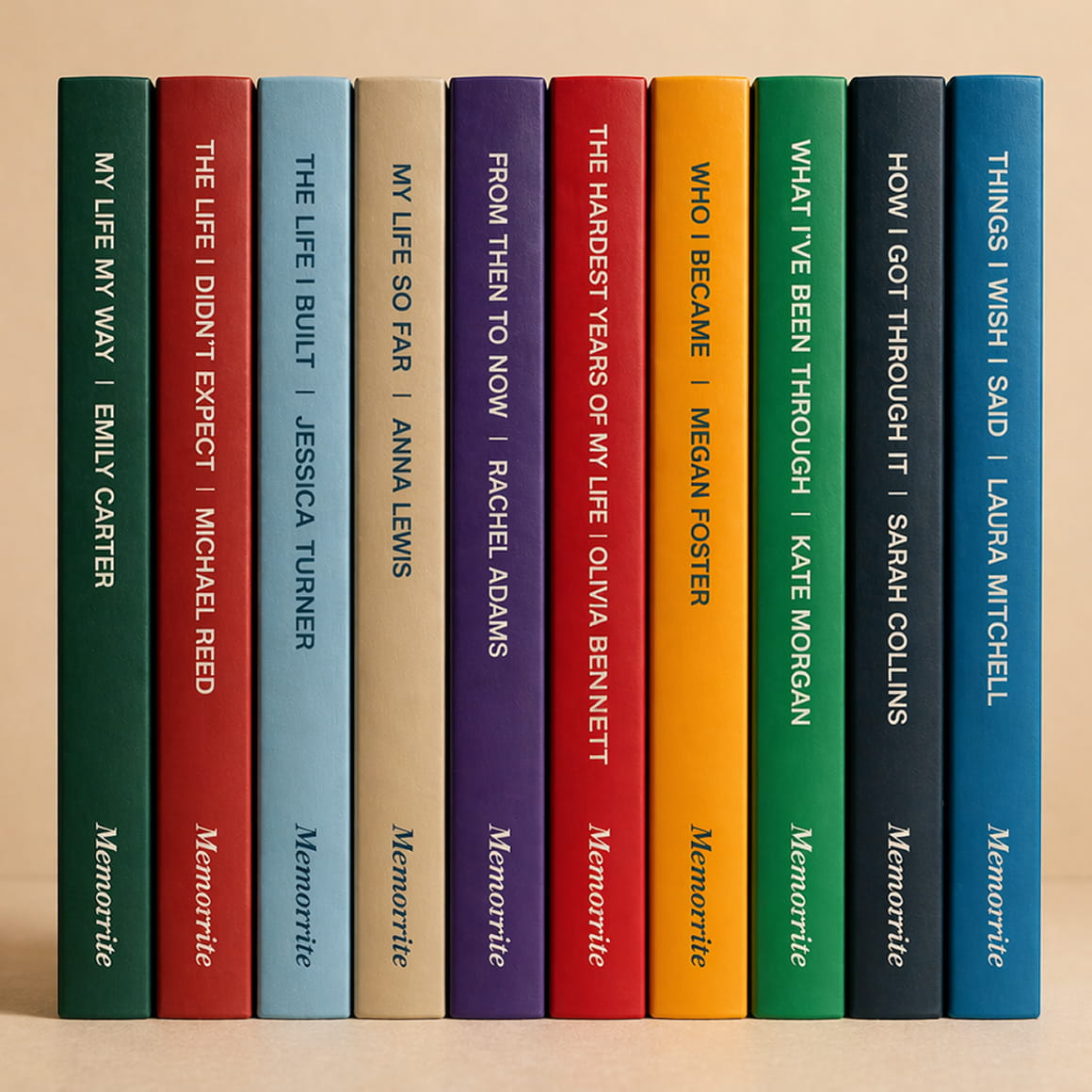 Row of ten colorful Memowrite memoir spines standing side by side